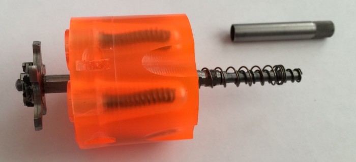 Put the extractor, center rod, and springs in place before screwing the ejector on.